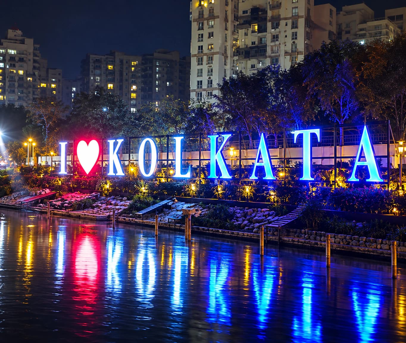 Illuminated 3D "I love Kolkata" letters reflected in water at night