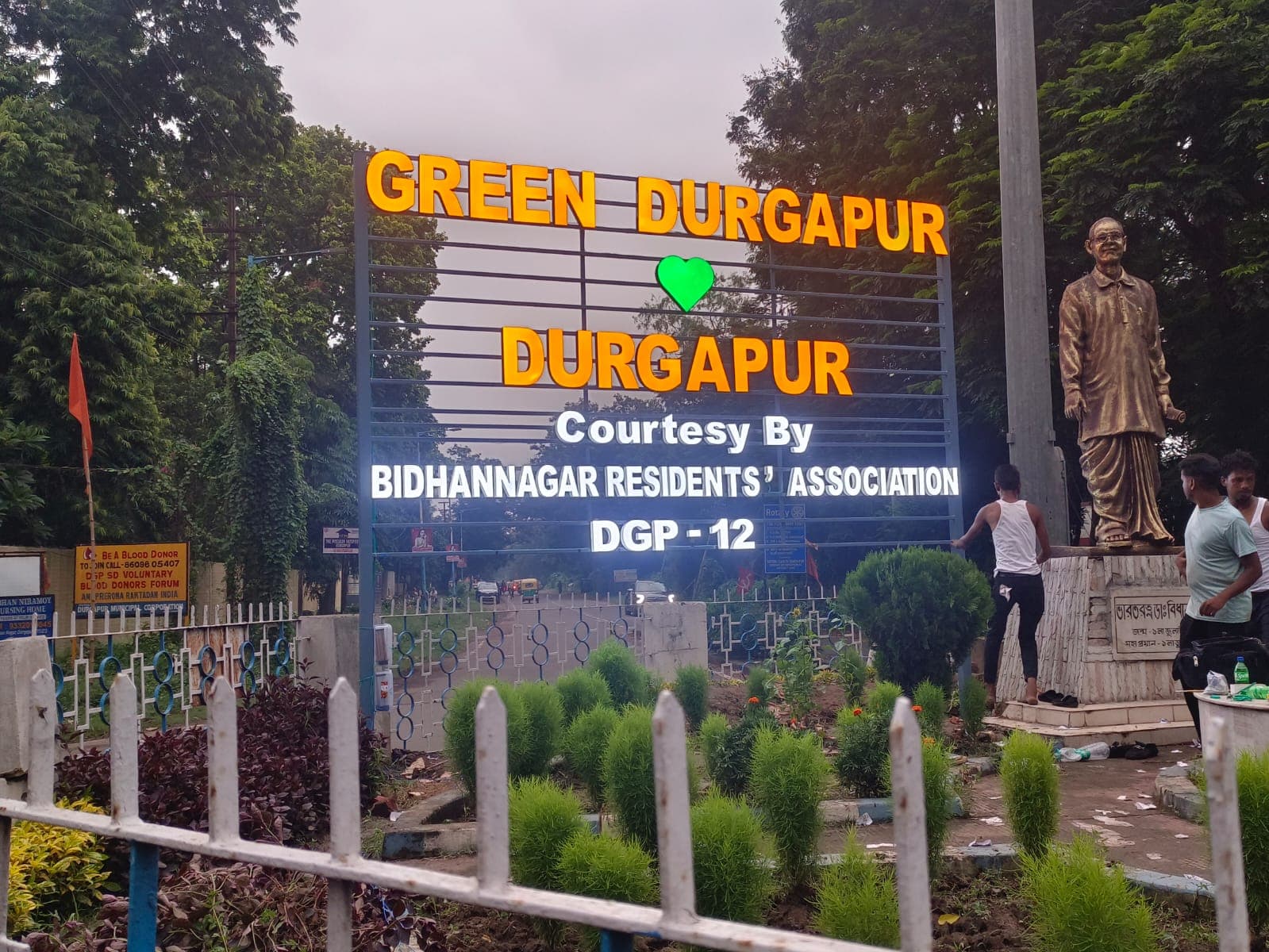 Illuminated GREEN DURGAPUR LED letter sign installed at a roadside garden in Durgapur